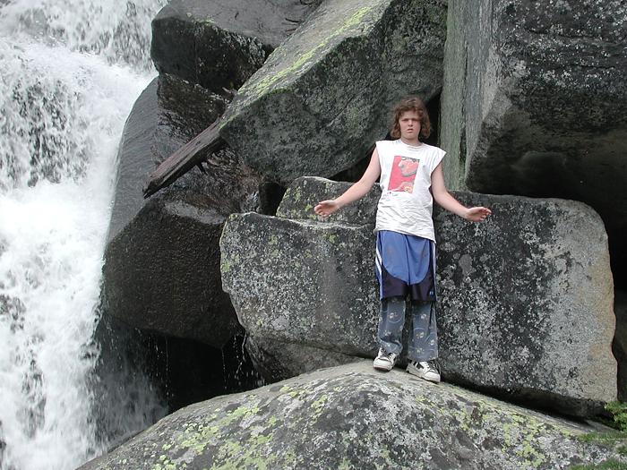 Andrew climbing next to waterfall