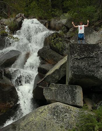 Andrew climbing next to waterfall
