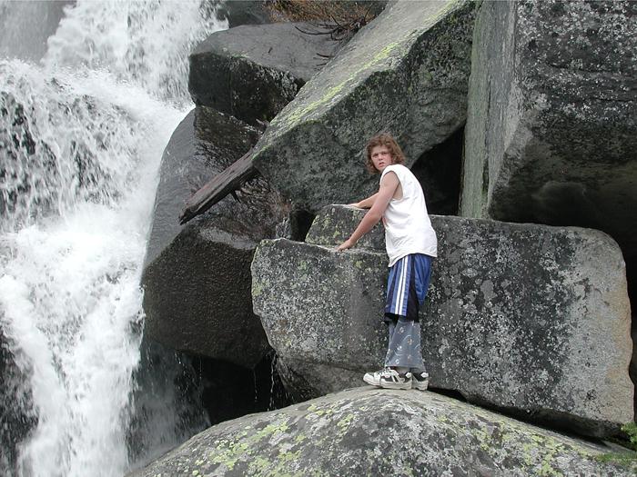 Andrew climbing next to waterfall