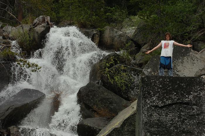 Andrew climbing next to waterfall