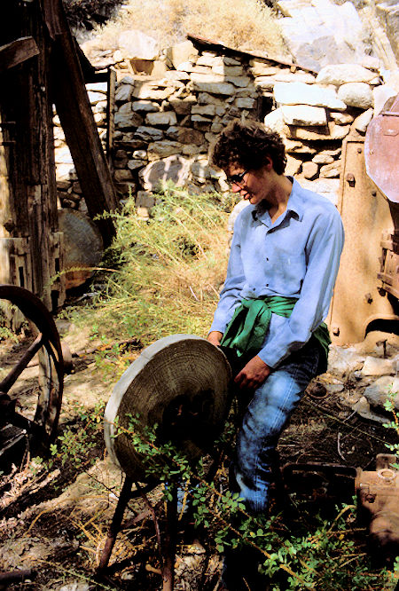 Jimmy White checks out grinding wheel near stamp mill boiler in 1981