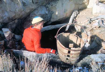 Cody Christenson and old ore bucket at a tunnel entrance at Pat Keyes Mine