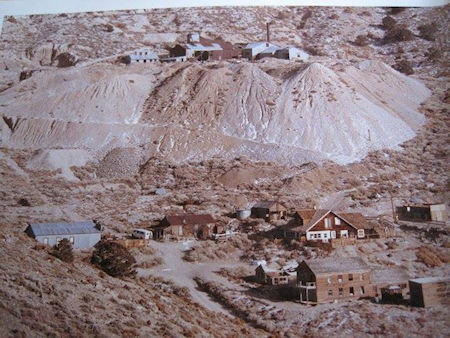 Overview of Cerro Gordo about 1988. Upper left is the Change Building next to the Union Mine Hoist House; Store, Belshaw House, Chinese Cook's Shack, Gordon House next; Crapo House and American Hotel at bottom. (Friends of Cerro Gordo Collection)