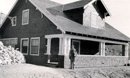 Worker in front of almost finished Gordon House about 1909