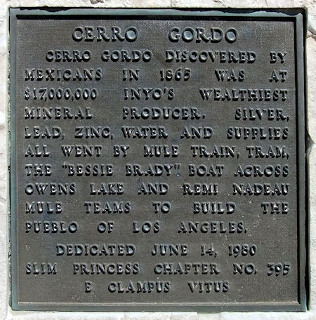 Historic marker placed by the Slim Princess Chapter No. 395 of E Clampus Vitus on June 14, 1980, at the bottom of the old Yellow Grade Road, aka Cerro Gordo Road, where it veers off from today's Highway 136 on the east side of Owens (Dry) Lake. Marker reads: CERRO GORDO Cerro Gordo discovered by Mexicans in 1865 was at $17,000,000 Inyo's wealthiest mineral producer. Silver, lead, zinc, water and supplies all went by mule train, tram, the 'Bessie Brady' boat across Owens Lake and Remi Nadeau mule teams to build the Pueblo of Los Angeles
