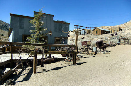 Mortimer Belshaw's general store (left) houses Cerro Gordo's museum today. Visible in the background just to the right of the museum are the remnants of the tramway structure below the Union Mine. The next structure is the assay office, and next to it, farthest right, is one of Lola's brothel cribs