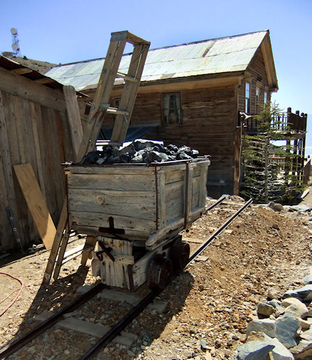 Ore cart, used to haul galena out of the Cerro Gordo mines. On display in the Cerro Gordo mining camp, where it's used as a bin for slag. Behind it at center is the American Hotel; at left is the Crapo house