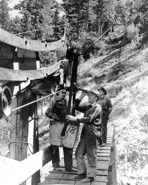 Workers at the lower tram house of the Tungsten Mill. Workers sometimes rode in <br>the ore buckets to avoid the 4,500-foot climb to the mine. This dangerous practice <br>proved fatal in one case - 1941