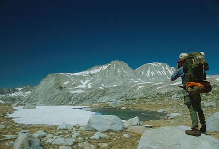 Gordon Lee photographing Merriam Peak and Royce Peak - 1982
