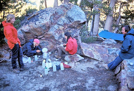 Paul Robotta cooks supper while Curt Sayer, Brian Twohey and Kevin Twohey look on Paul Robotta cooks supper while Curt Sayer, Brian Twohey and Kevin Twohey look on