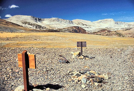 Looking westerly from Parker Pass you see the Kuna Crest. Helen Lake is located in the basin between the red and the gray rock on the left edge of the picture. There are also lakes in the two basins where you can see a small patch of snow Looking westerly from Parker Pass you see the Kuna Crest. Helen Lake is located in the basin between the red and the gray rock on the left edge of the picture. There are also lakes in the two basins where you can see a small patch of snow