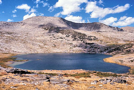 Helen Lake with the Kuna Crest on the skyline. There is a lake in the basin just right of center. It's a relatively easy hike up the slopes on the left to the top of the Kuna Crest Helen Lake with the Kuna Crest on the skyline. There is a lake in the basin just right of center. It's a relatively easy hike up the slopes on the left to the top of the Kuna Crest