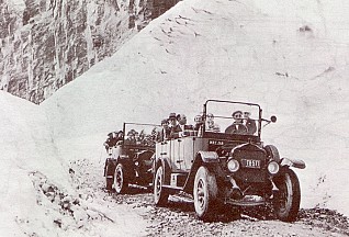 The first two buses over Logan Pass during the Dedication Ceremony July 15, 1933 - National Park Service photograph, 1933