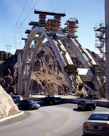 As seen from the existing US 93 hairpin curve in Nevada, pier construction on the arch to support the roadway progresses - October 2009