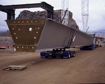A truck transports a 115 foot long steel girder onto the Nevada approach and waits for off loading - January 2010
