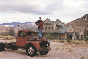 Rocky on old truck in front of Rhyolite Railroad Station