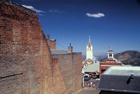 Old brick building wall and general scene toward the fire house and St. Mary Catholic Church, Virginia City, Nevada