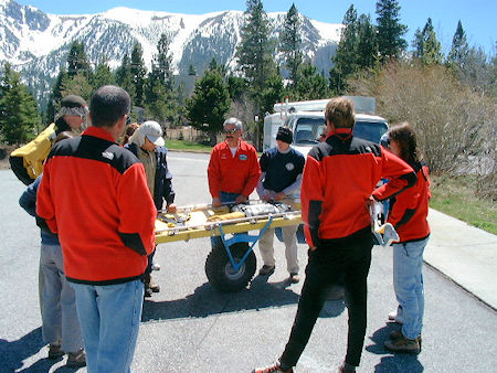 Bill Greene demonstrates wheeled litter handling to new candidates - May 11, 2002