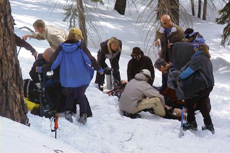 Snowmobile crash victim being treated at scene of the accident