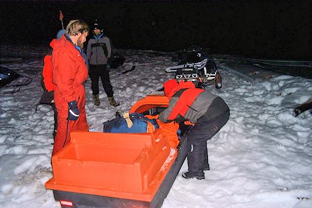 Night rescue exercise - making the victim comfortable in the sled