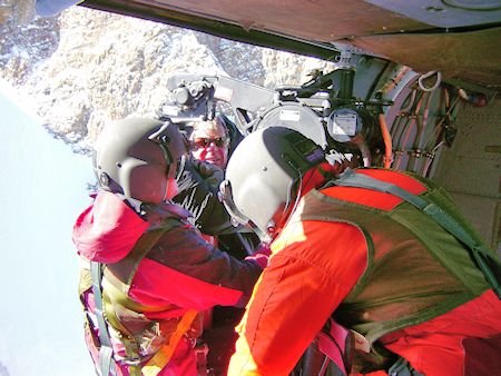 Rescuer and subject hauled up to helicopter