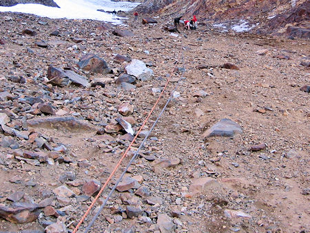 Belay line down over the boulders to the snow slope