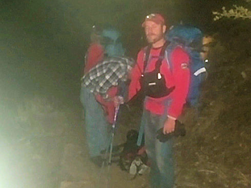 Team hiking in after dark