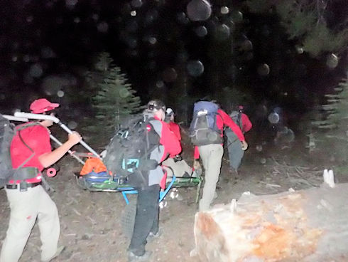 Moving wheeled liter up the trail in the dark
